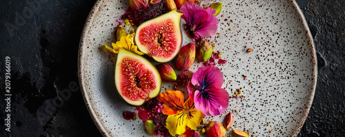 Fresh Figs with Edible Flowers and Pistachios on Ceramic Plate