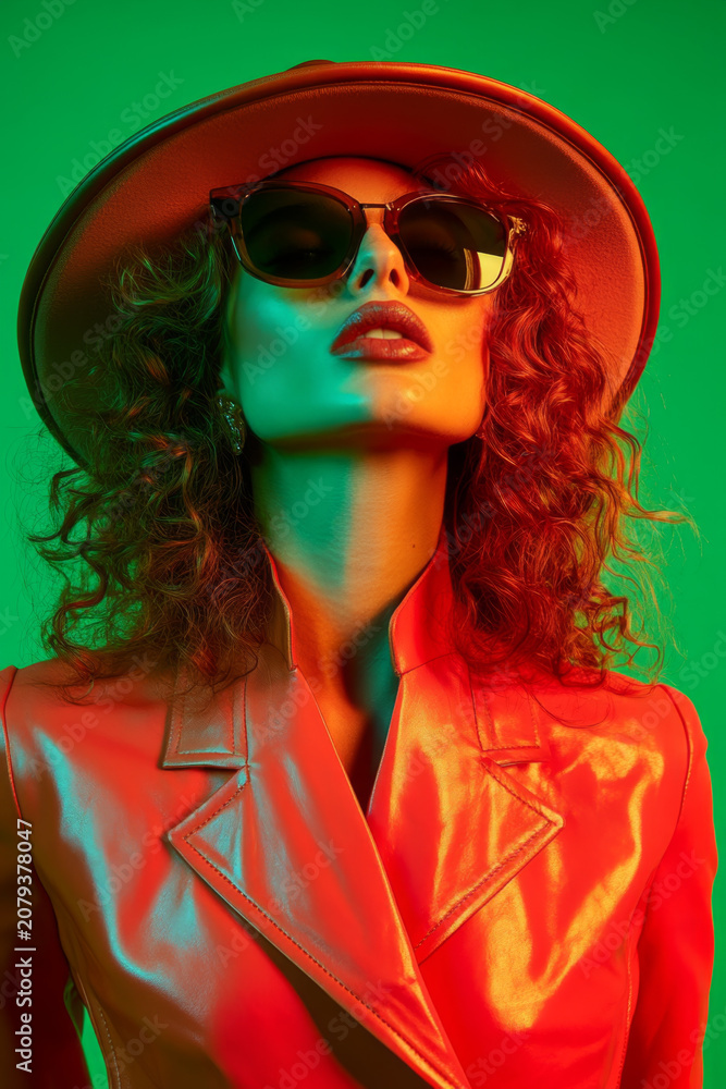Obraz premium Fashionable Woman in Red Leather Jacket with Sunglasses