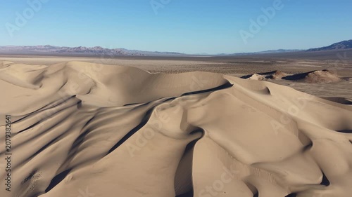 drone fly over of dumont dunes and surrounding mountains in the california mojave desert