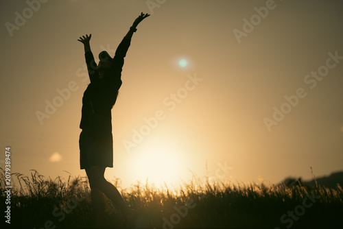 Silhouette woman sunset fie...