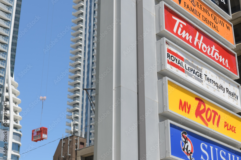 Obraz premium roadside pylon featuring business directory signage outside Shoppes Of the World Trade Centre, a shopping mall, 10 Queens Quay W at Yonge St, Toronto