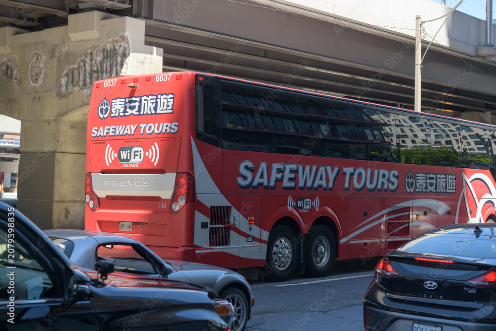 Obraz premium Safeway Tours coach heading eastbound on Lake Shore Blvd E, Toronto