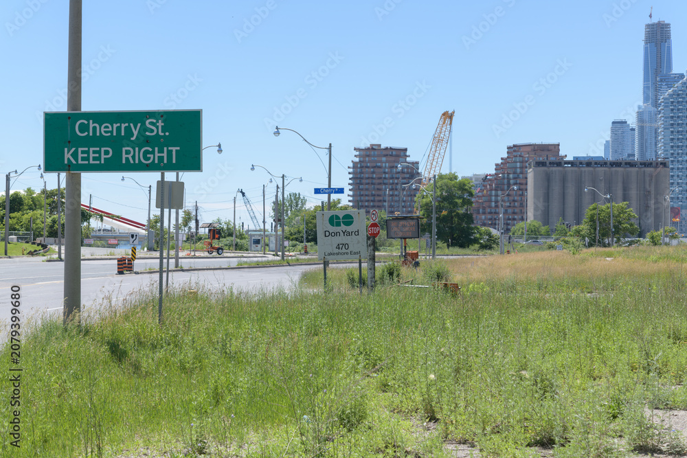 Obraz premium looking west from shoulder of road to Go Transit sign at Don Yard 470 Lake Shore Blvd E, Toronto