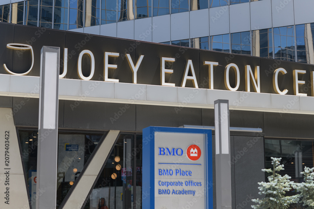 Obraz premium Joey Eaton Centre, a restaurant, and BMO Financial Group and corporate logo sign outside entrance to BMO Place at CF Toronto Eaton Centre located at 33 Dundas St W