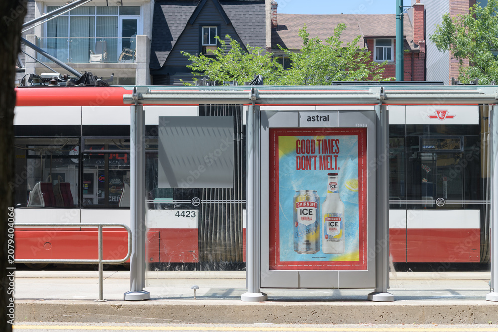 Obraz premium defocused trolley and transit shelter advertising for Smirnoff Ice (by Diageo) on Spadina Av, Toronto