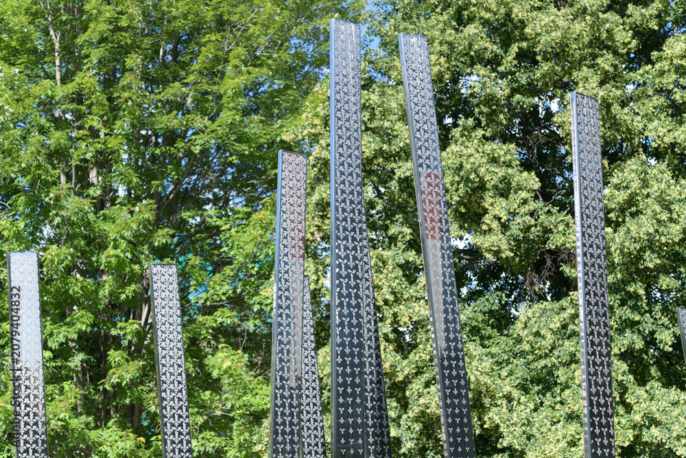 Obraz premium “Notre Place” – Monument to Franco-Ontarians, featuring tall stainless steel vertical staves with flag color and pattern, College St / University Av, Queen's Park edge, Toronto
