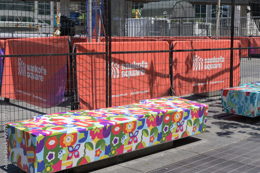 Obraz premium mesh banners at Sankofa Square with colorful benches, Toronto
