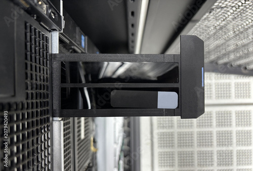 Blank server service tag mockup on a drive caddy handle inside a data center rack