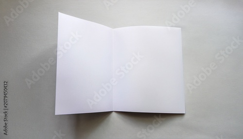 Blank White Sheet Of Paper Folded In Half White Background Place For Text Copy Space