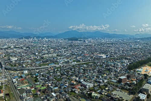 Bild auf Leinwand Aerial drone photo of Shizuoka city urban sprawl with mountains in background, J