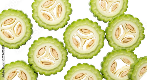 Fresh bitter melon slices healthy food ingredient close up top view transparent background