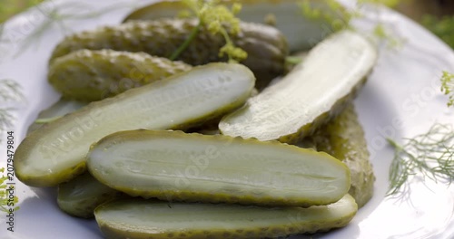 Traditional pickled cucumbers, pickled using the natural fermentation method, on a plate, close-up view