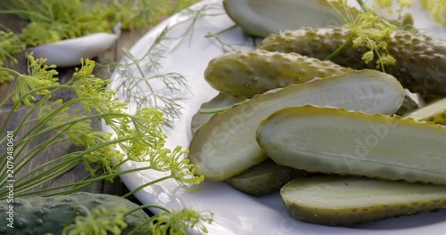 Traditional pickled cucumbers, pickled using the natural fermentation method, on a plate, close-up view