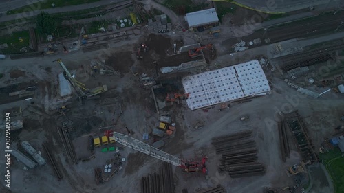 drone footage overlooking active construction with cranes excavators and new residential buildings highlighting urban expansion and engineering work
