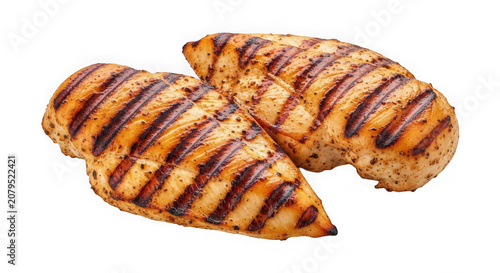 Two delicious grilled chicken breast fillets with charred grill marks isolated on transparent background