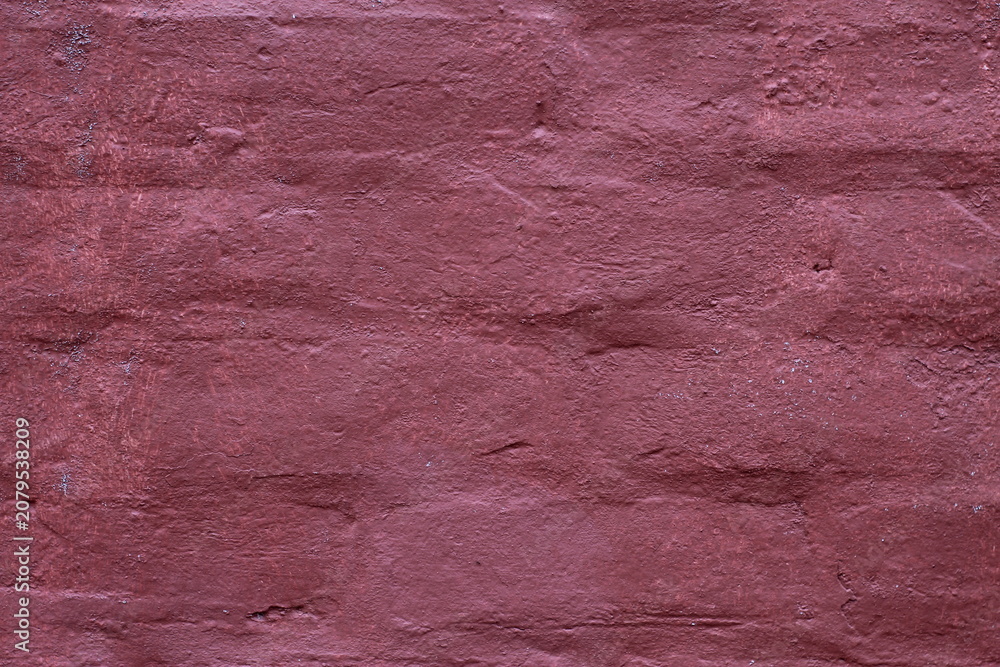 Naklejka premium Textured background of an old weathered brick wall painted in a deep dark maroon color