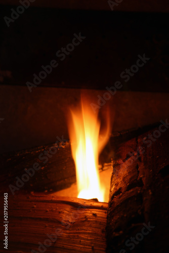 Burning wood with big red and orange flames. Fascinating abstract view symbolizing cooking, warmth, camping - and on the other hand burning, danger and hell. Closeup image.