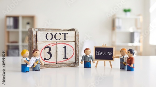 October 31st Deadline Concept with Wooden Figures and Calendar in Office Setting