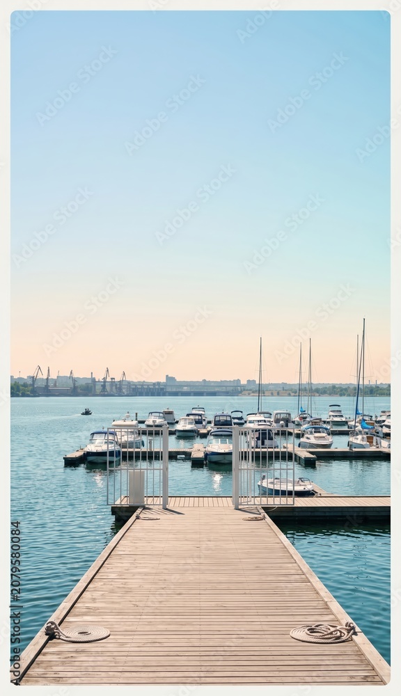 Fototapeta premium Marina entrance gate and dock leading to moored yachts on a sunny day