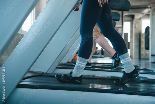 Obraz na plátně Treadmill gym woman leg workout fitness exercise running shoe sock, close view o
