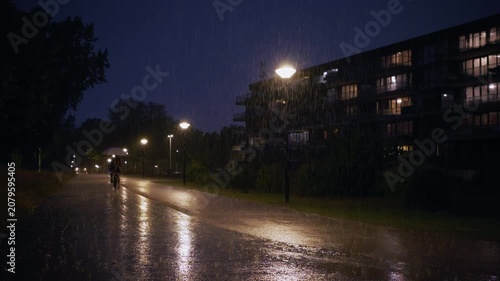 Slow Motion of Cyclists in Rain with and without Umbrella