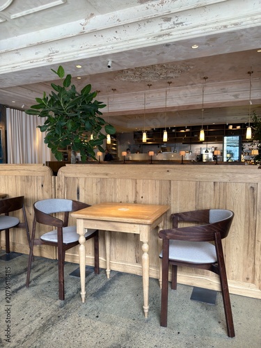 Cozy modern cafe interior with wooden furniture and warm lighting