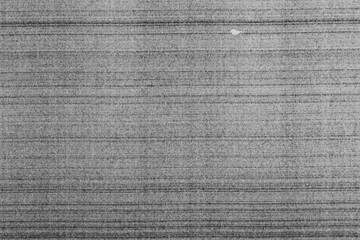 Monochrome macro shot of an inkjet print on a white piece of paper, with interesting patterns and digital textures