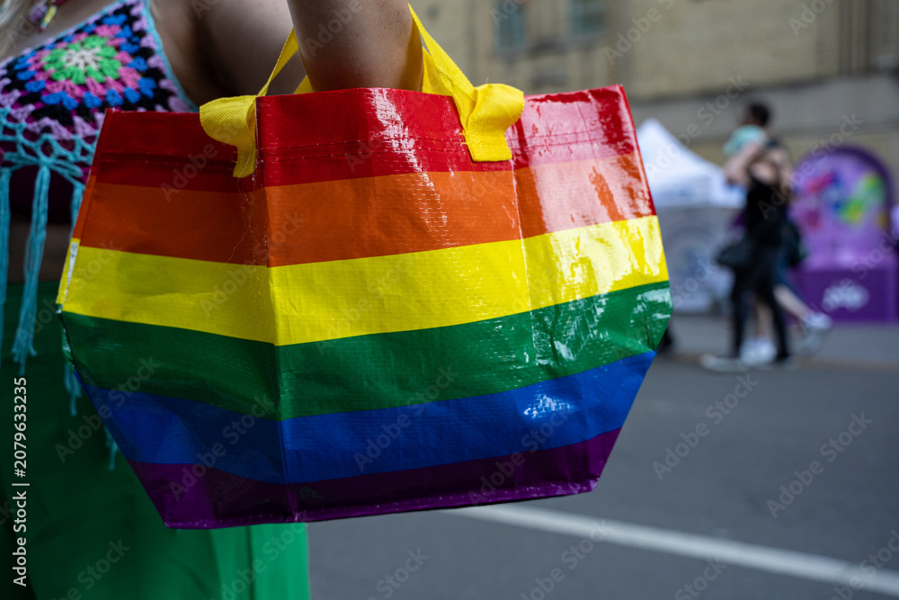 Obraz premium Close up of rainbow pride tote bag at street festival.