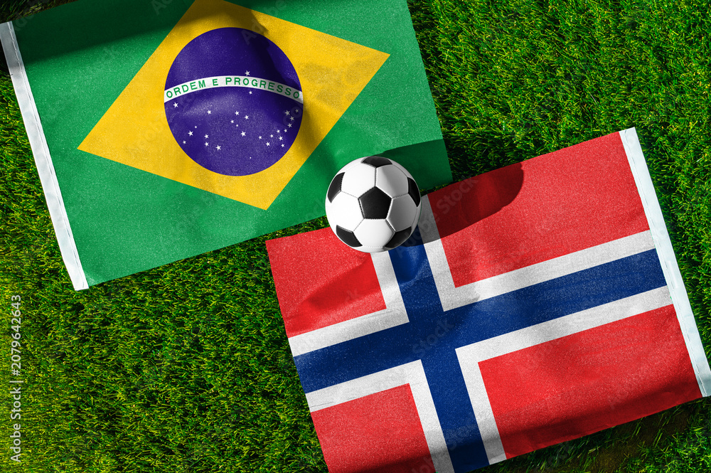 Obraz premium Brazil vs Norway, national flags before international football tournament Round of 16 match, football on green grass with stadium in the background, East Rutherford, New Jersey, USA, July 5, 2026