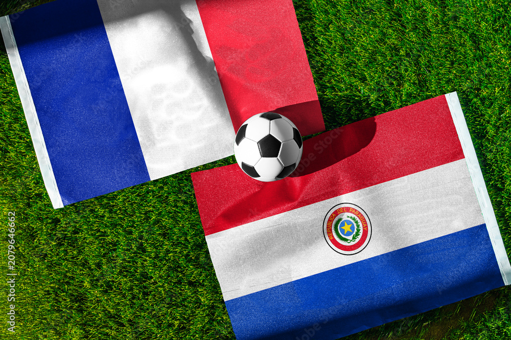Obraz premium France vs Paraguay, national flags before international football tournament Round of 16 match, football on green grass with stadium in the background, Lincoln Field, Philadelphia, USA, July 4, 2026