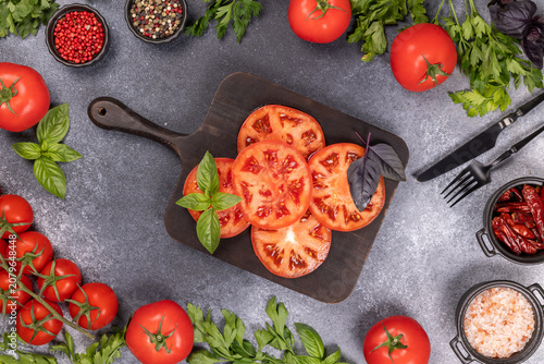 Fresh tomatoes, basil, and spices preparing healthy cooking