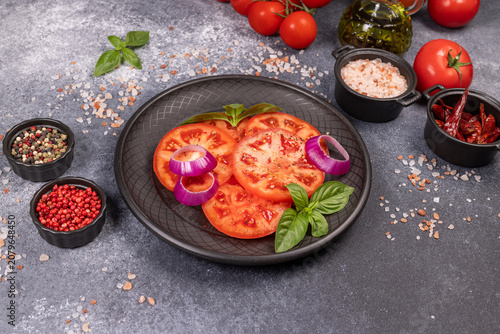 Sliced tomato salad with red onion and basil