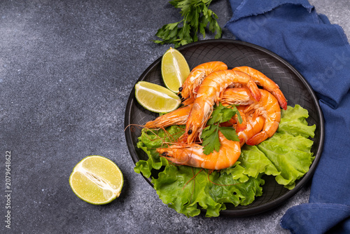 Fresh cooked prawns on lettuce with lime