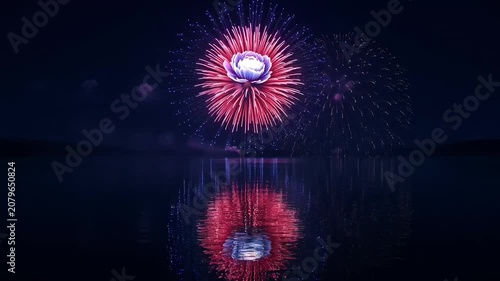 Vibrant fireworks bloom over dark water, reflecting a spectacular night sky display.