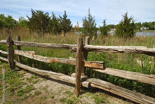 Obraz na płótnie Wooden fence along rural road in Poquott Village