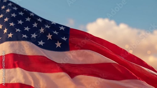 American flag waving proudly against a bright, cloudy sky