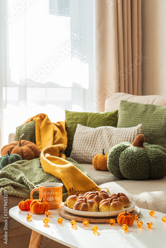 Cozy autumn pumpkin bread buns and mug on table