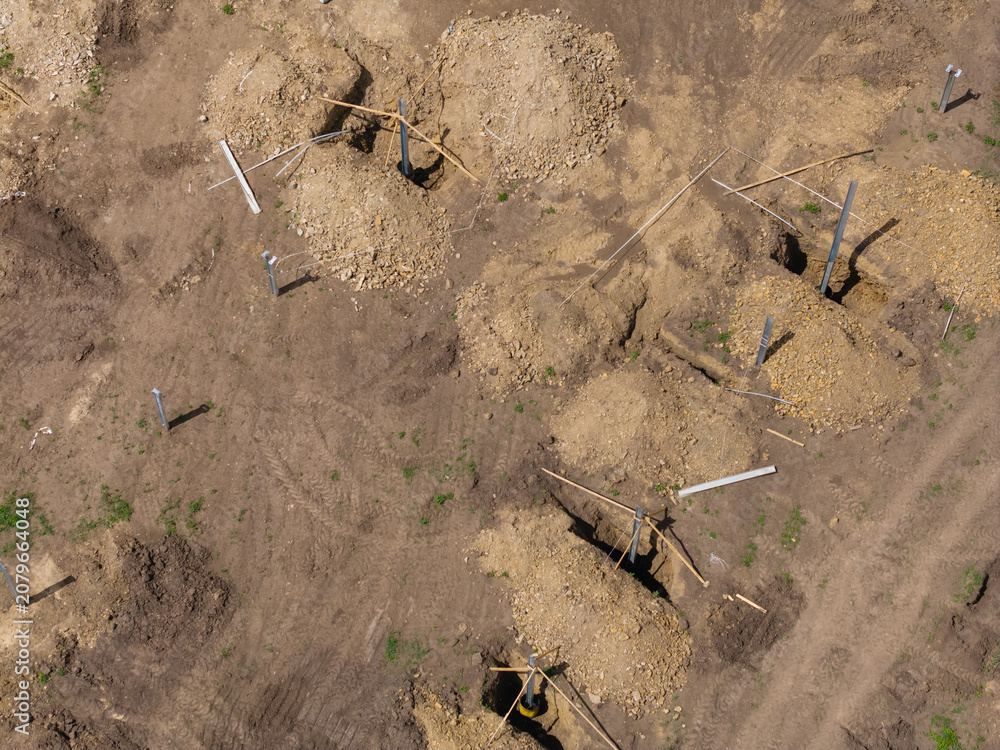 Fototapeta premium Aerial view of construction site for solar panels farm and machinery in progress