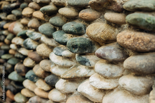 Obraz na płótnie Background with the texture of a stone wall made of pebbles