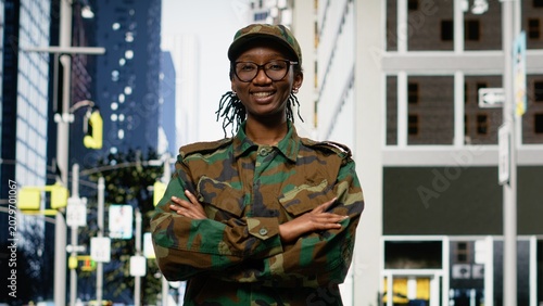 Obraz na plátne Strolling on sidewalk downtown, city street and happy army soldier admiring skyscrapers on avenue, black officer enjoying military leave and sightseeing in the metropolitan area for business workflow