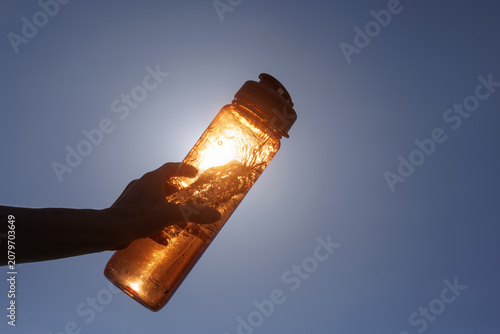 Refreshing Water Bottle Against Bright Sunlight on a Hot Day