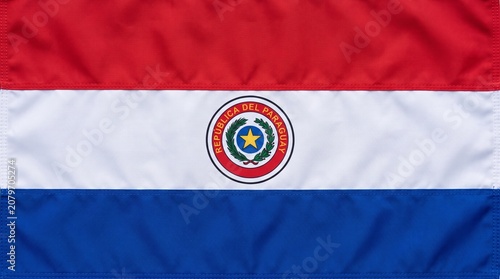 Paraguay flag with red, white, and blue stripes and central coat of arms, symbolizing national identity, pride, and unique dual‑sided design heritage.
