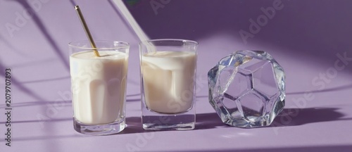 Milkshakes and decorative crystal on a purple surface studio shot