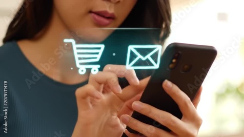 Close-up of smartphone user with holographic shopping icons.