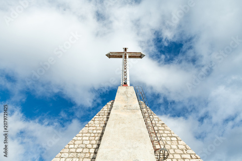 Historic military memorial cross against blue sky in Abruzzo Italy
