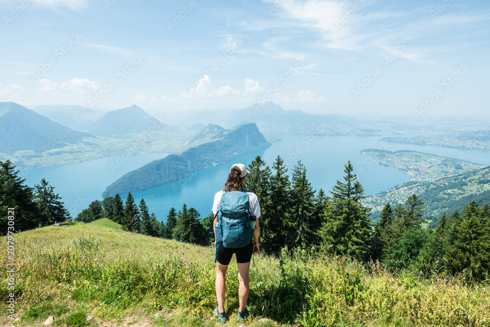 Obraz premium Hiker enjoying panoramic lake lucerne view from mount rigi