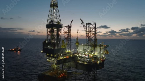aerial, offshore, jack-up, rig, platform, oil, gas, exploration, production, energy, sunset, twilight, dusk, industrial, maritime, ocean, sea, horizon, sky, orange, derrick, crane, legs, lattice, stee
