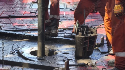 Drilling rig activity - Pull of of hole drill string with oil based mud on the rig floor. Trip out of hole.