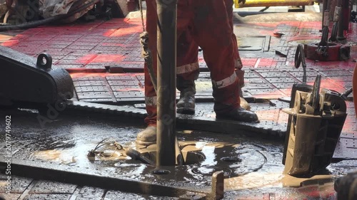 Drilling rig activity - Pull of of hole drill string with oil based mud on the rig floor. Trip out of hole.