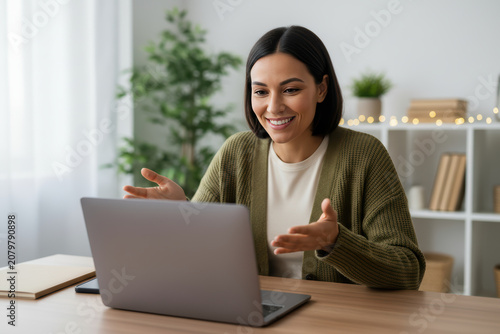 Smiling woman having a video call on a laptop at home